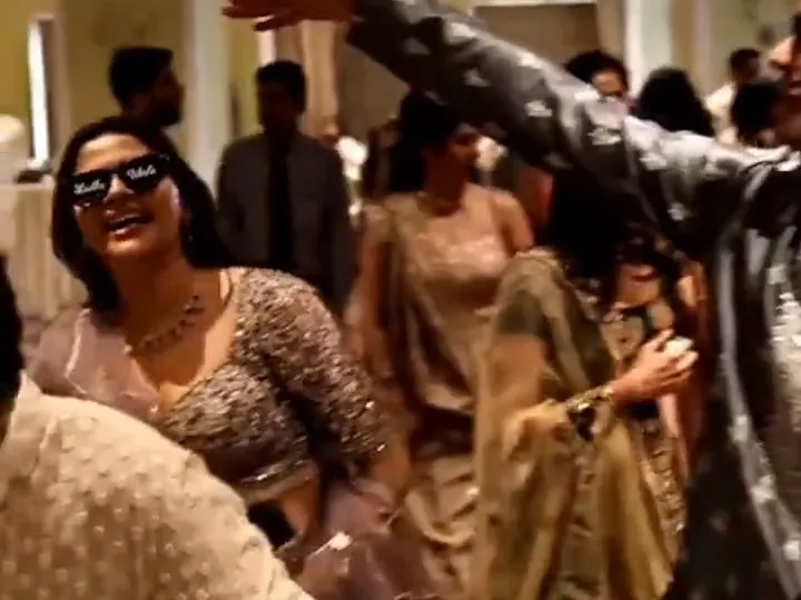 Guests in lehengas and kurtas dancing at a sangeet with Sound Impulse sound and DJ