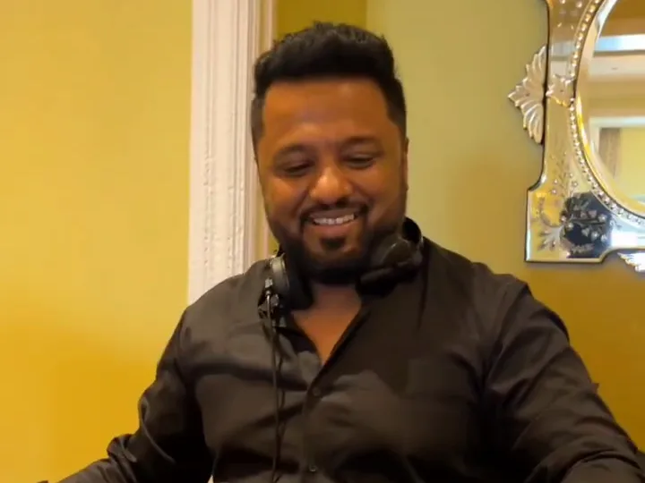 DJ Amit Punjabi with headphones on, playing a wedding sangeet