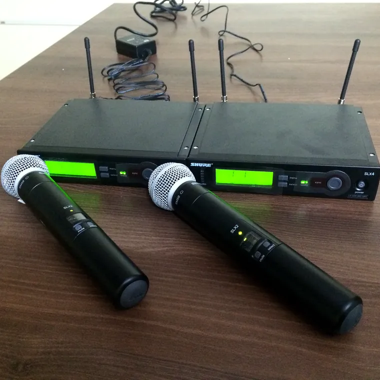 Two Shure SLX wireless microphones with receivers