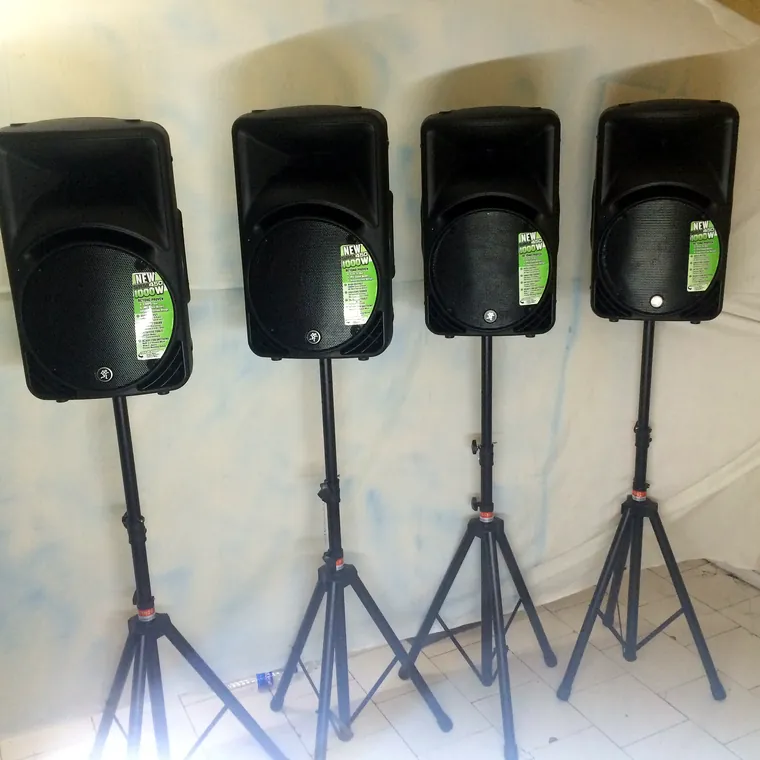 Four Mackie SRM450 speakers on tripod stands
